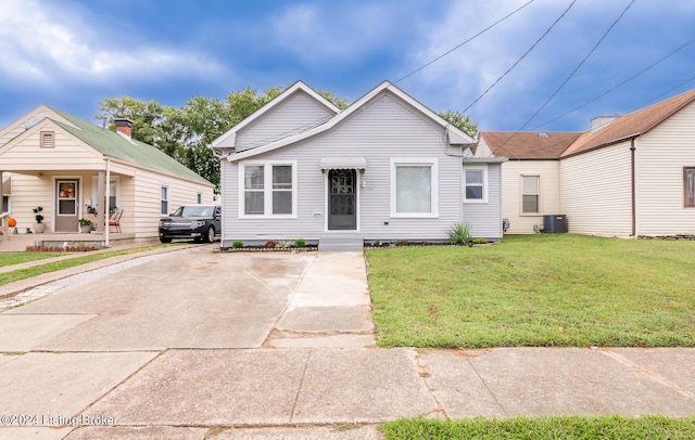 view of front facade featuring central AC unit and a front yard