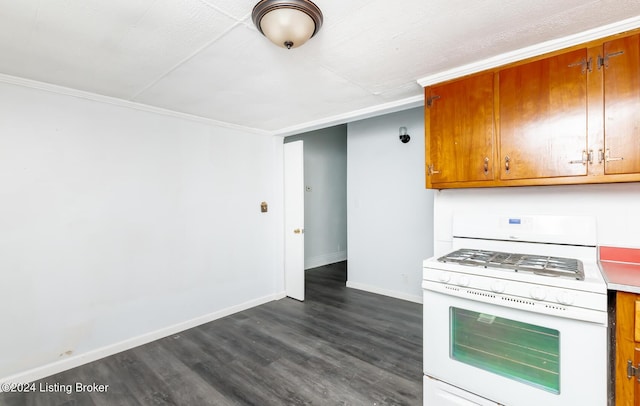 kitchen featuring brown cabinets, white range with gas stovetop, baseboards, and dark wood finished floors