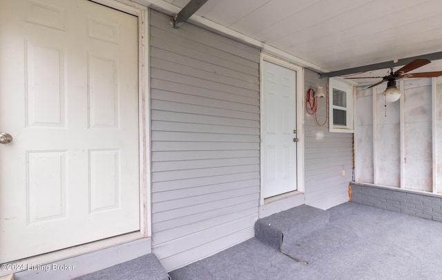 entrance to property with a ceiling fan