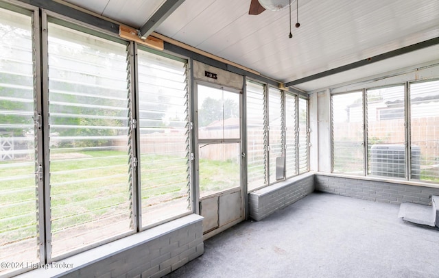 unfurnished sunroom featuring ceiling fan and a wealth of natural light