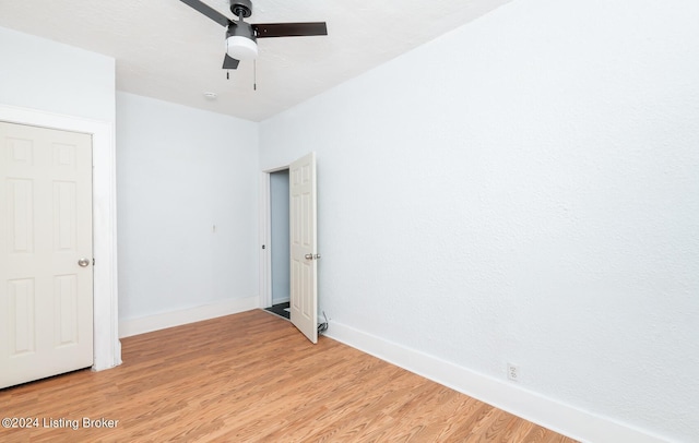 unfurnished bedroom featuring ceiling fan, light wood finished floors, and baseboards