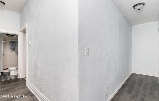 interior space featuring baseboards and wood finished floors