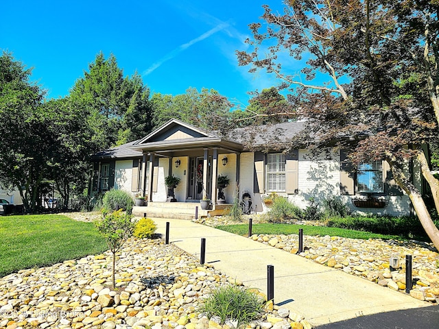 ranch-style house featuring brick siding, a porch, and a front yard