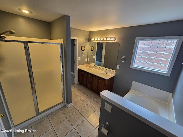 bathroom with a sink, a shower stall, a bath, and double vanity