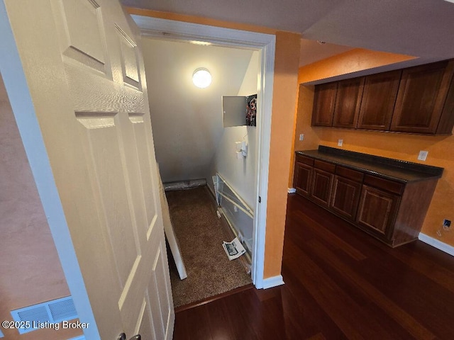 hall with baseboards and dark wood-style flooring