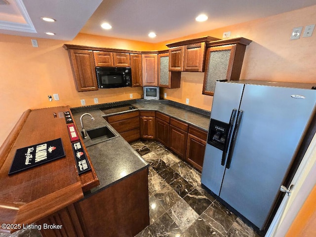 kitchen featuring recessed lighting, a sink, marble finish floor, black appliances, and dark countertops