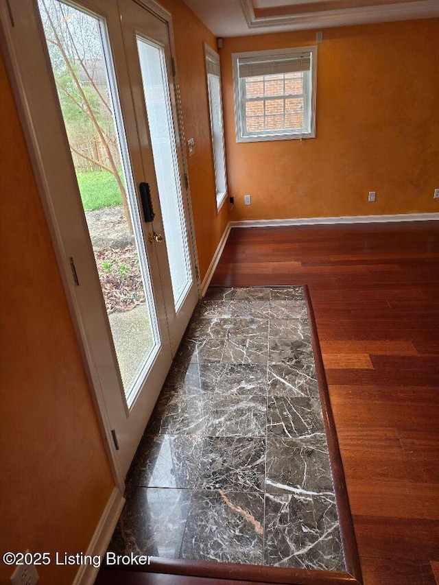 doorway to outside with a wealth of natural light, baseboards, wood finished floors, and french doors