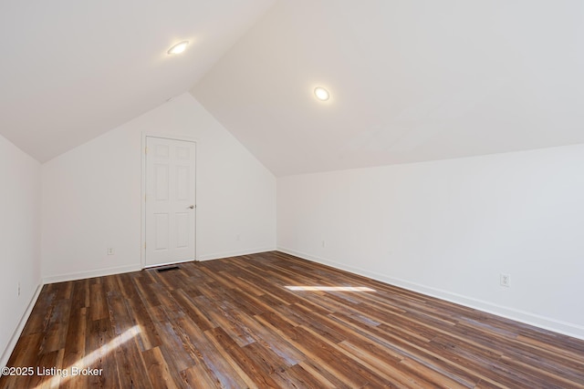 additional living space with lofted ceiling, dark wood-style flooring, baseboards, and recessed lighting