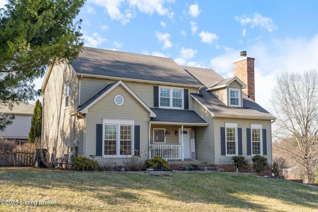 view of front of home with covered porch, a front lawn, a chimney, and fence