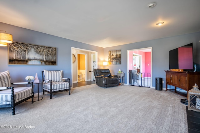 living area with carpet floors and baseboards