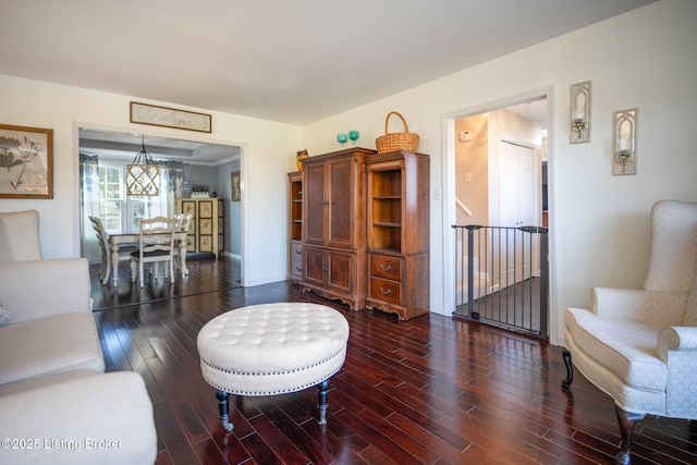 living area featuring baseboards and dark wood-style flooring