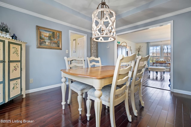 dining room featuring an inviting chandelier, baseboards, dark wood finished floors, and crown molding