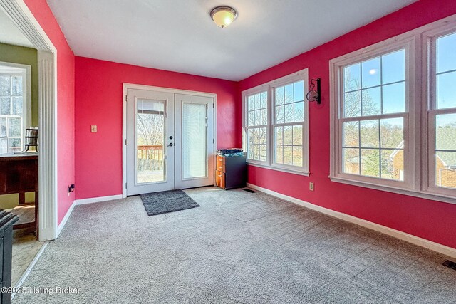 doorway with baseboards, french doors, and a healthy amount of sunlight