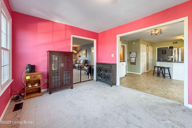 carpeted living room featuring baseboards and visible vents