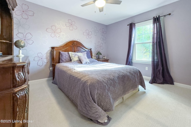 bedroom with ceiling fan, baseboards, and light colored carpet