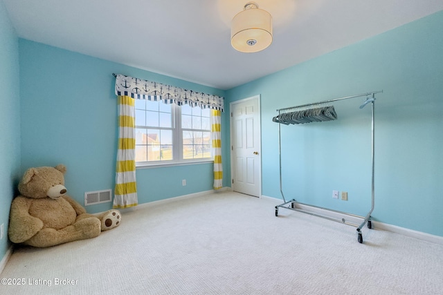 interior space featuring carpet flooring, visible vents, and baseboards