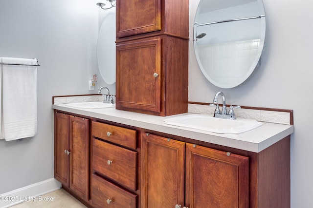 bathroom featuring double vanity, a sink, and baseboards