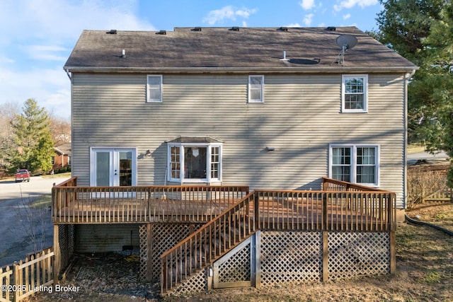 back of property with a deck and stairway