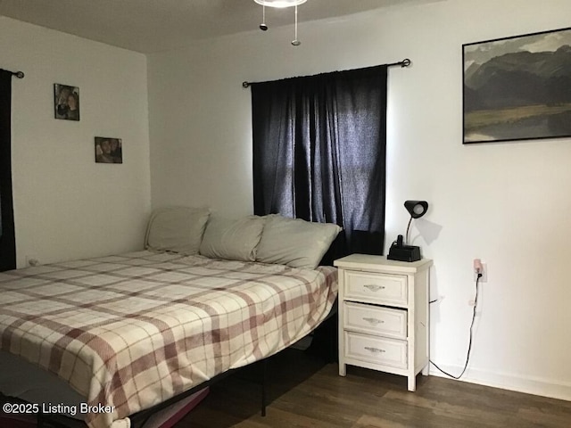 bedroom with dark wood-type flooring