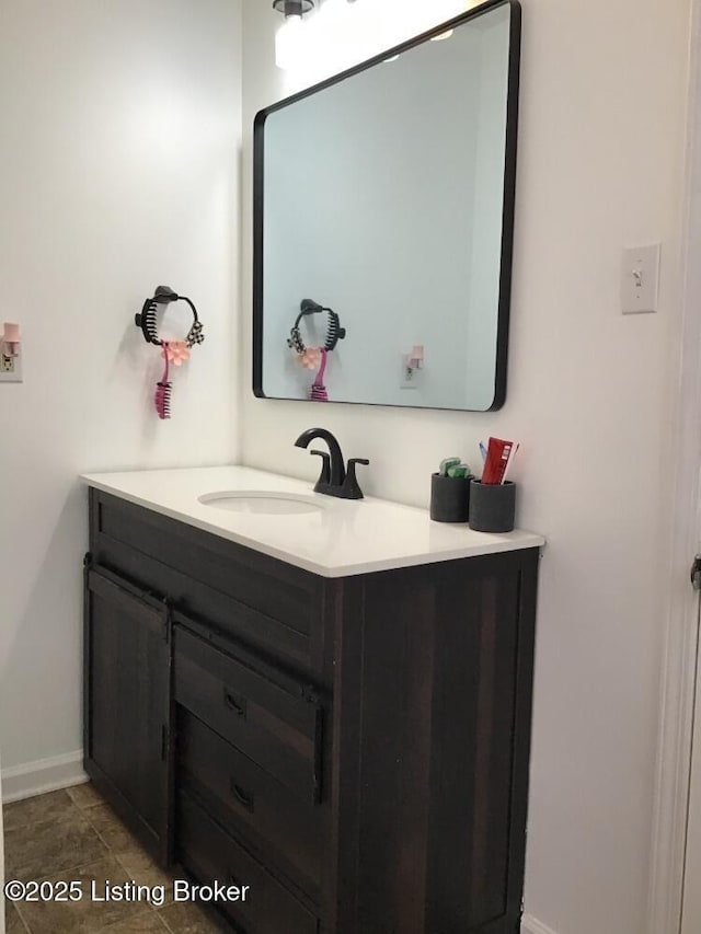 bathroom featuring baseboards and vanity