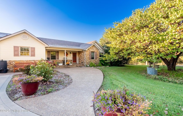 single story home featuring stone siding, covered porch, and a front lawn