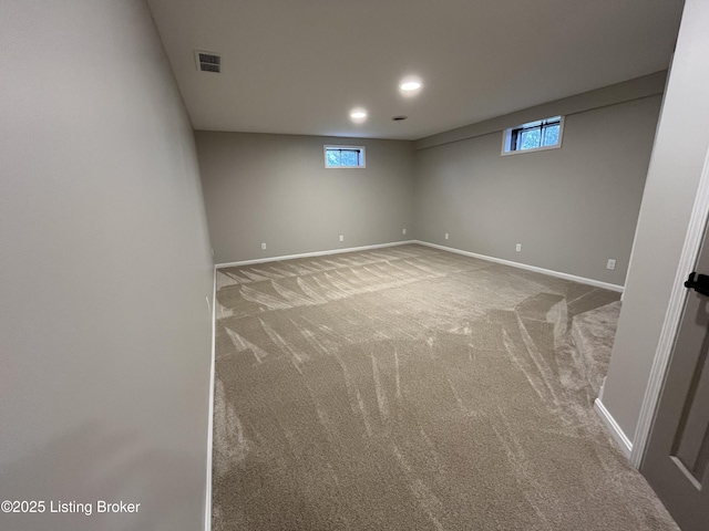 basement with carpet, visible vents, baseboards, and recessed lighting