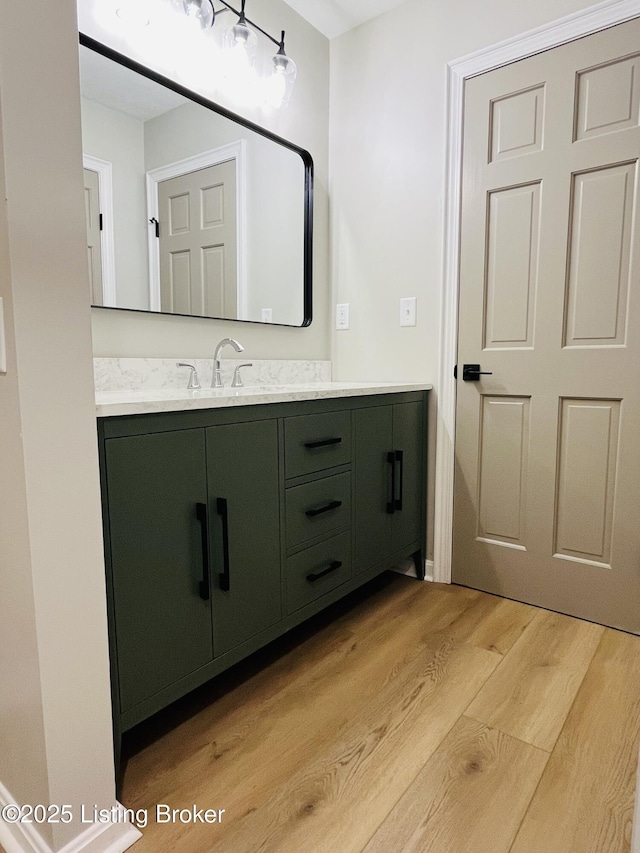 bathroom with wood finished floors and vanity