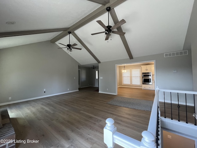 unfurnished living room with visible vents, a ceiling fan, wood finished floors, beamed ceiling, and baseboards