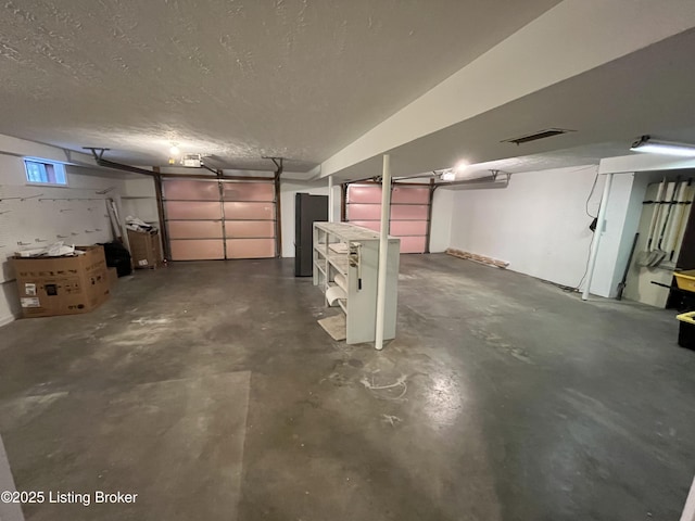 garage with a garage door opener and visible vents