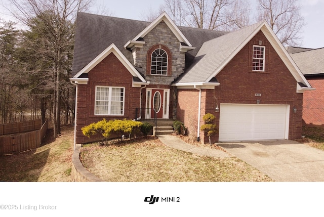 traditional home with stone siding, brick siding, and concrete driveway