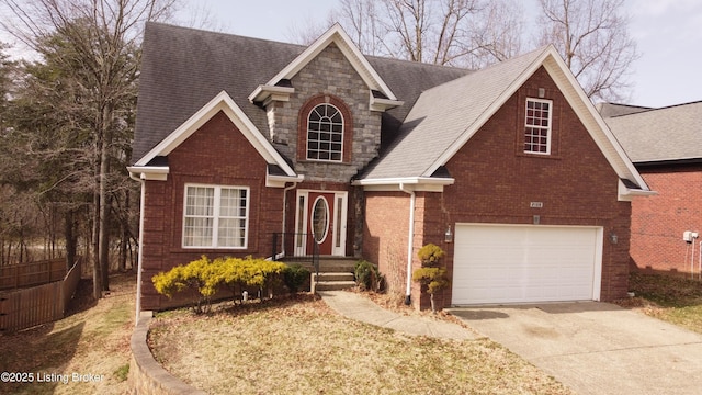 view of front of property with an attached garage, brick siding, stone siding, concrete driveway, and roof with shingles