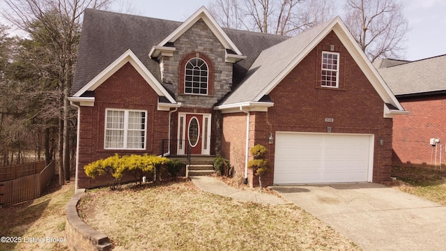 traditional home with a garage, brick siding, fence, stone siding, and driveway