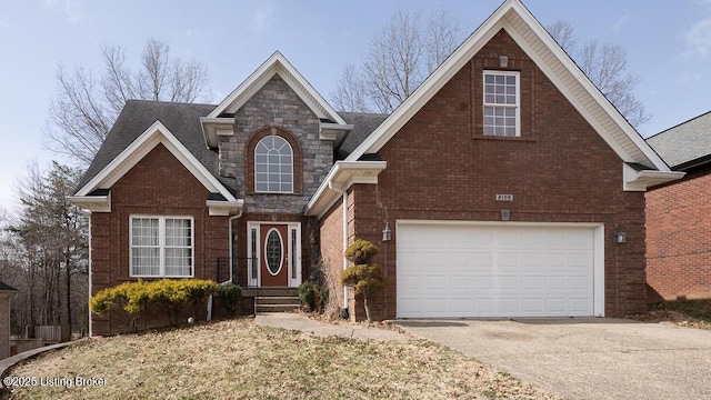 traditional-style house featuring driveway, stone siding, roof with shingles, an attached garage, and brick siding