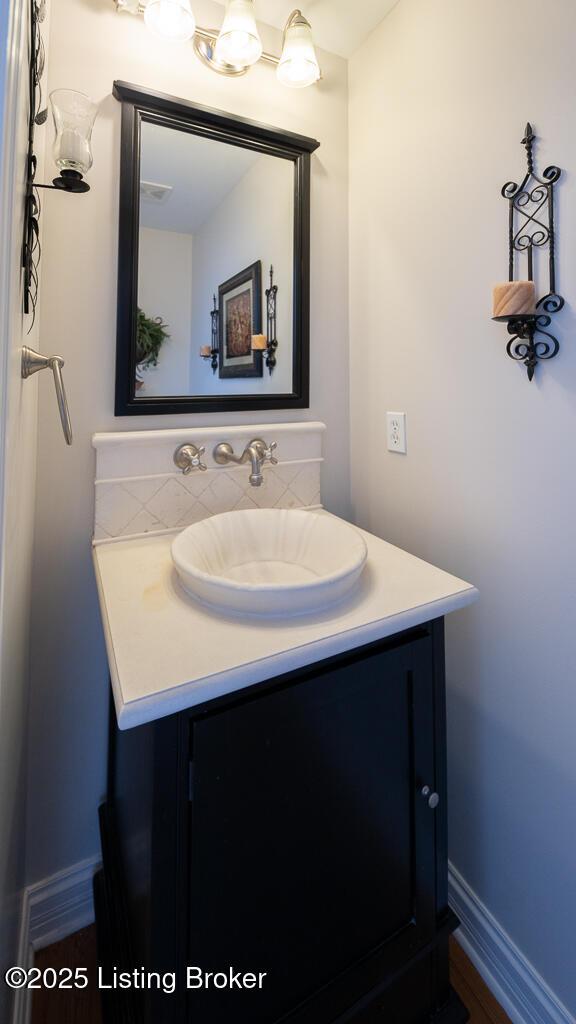 bathroom with backsplash and vanity