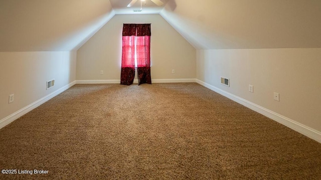 bonus room featuring baseboards, visible vents, vaulted ceiling, and carpet flooring