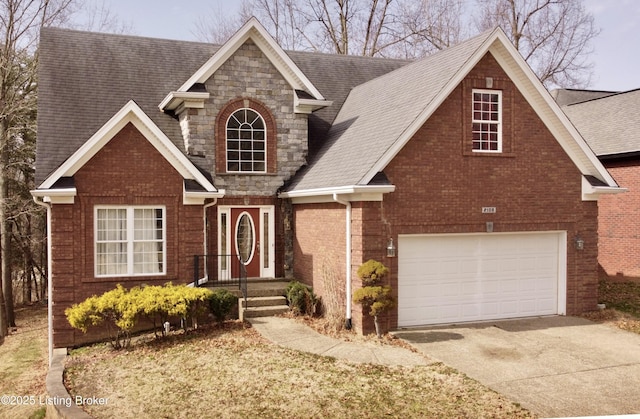 traditional-style house with an attached garage, brick siding, a shingled roof, stone siding, and driveway