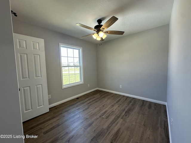 empty room with visible vents, baseboards, dark wood-style flooring, ceiling fan, and a textured ceiling