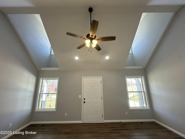 interior space featuring dark wood-style floors, baseboards, and ceiling fan