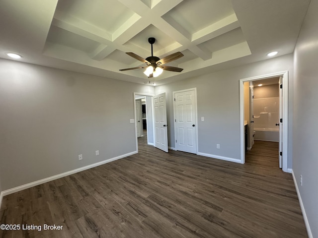 unfurnished bedroom with dark wood finished floors, coffered ceiling, and baseboards