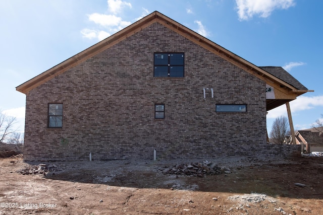 view of property exterior with brick siding