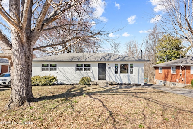 ranch-style house featuring concrete driveway, brick siding, and a front yard