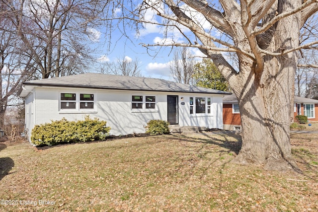 ranch-style house with a front yard, brick siding, and entry steps