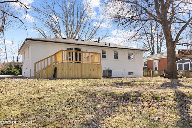 rear view of property with brick siding, fence, cooling unit, a wooden deck, and stairs