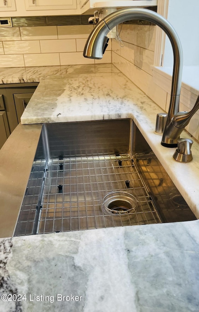 interior details with a sink and backsplash