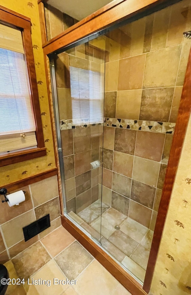 full bathroom featuring a shower stall and tile patterned floors