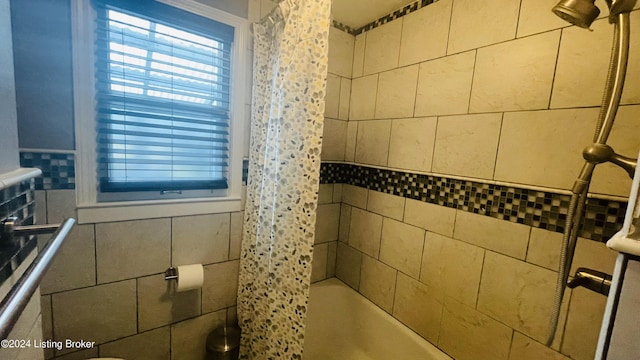 full bath featuring shower / bath combination with curtain and tile walls