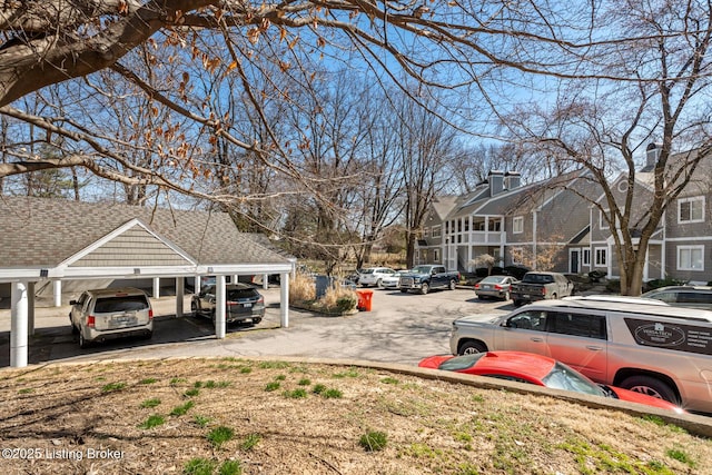 view of car parking with a residential view