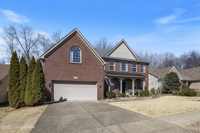 traditional home featuring a garage, brick siding, a porch, and concrete driveway