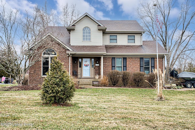 traditional-style house with brick siding, roof with shingles, and a front yard