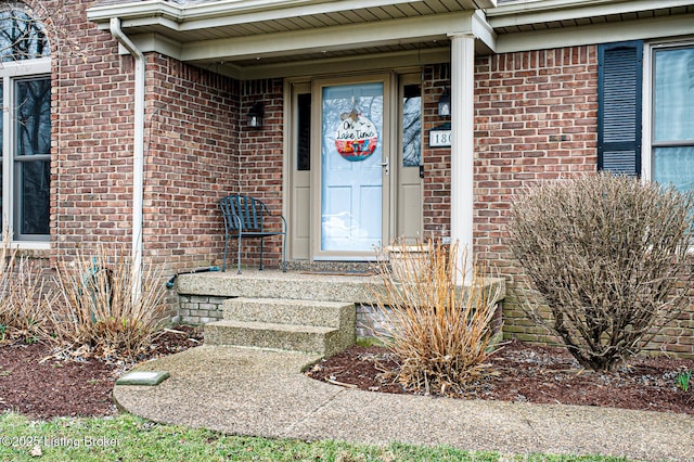 view of exterior entry with brick siding